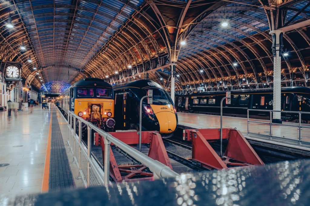 Londons Paddington Station showcasing modern trains under its iconic roof archway.